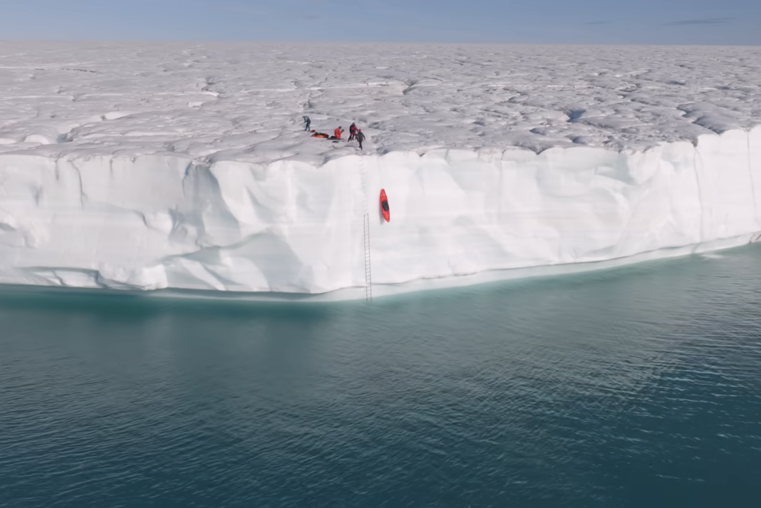 Hoisting a kayak up a glacier.